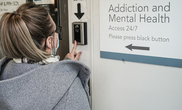 A woman checks into the Addiction and Mental Health Access 24/7 centre.
