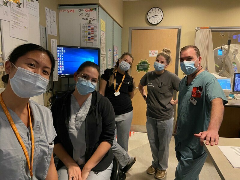 Five team members from the Diagnostic Imaging department, wearing scrubs and masks.