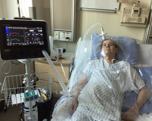 Christopher McKenzie breathes easy under a canopy while the Q-NRG+ metabolic monitor determines his resting energy expenditure, helping dietitians at the Royal Alexandra Hospital tailor his nutrition needs.