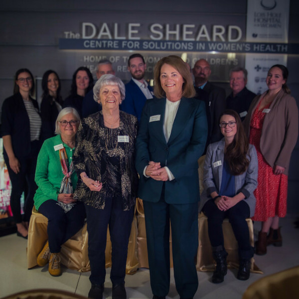 Dale Sheard (front, right) joined by loved ones at sign unveiling