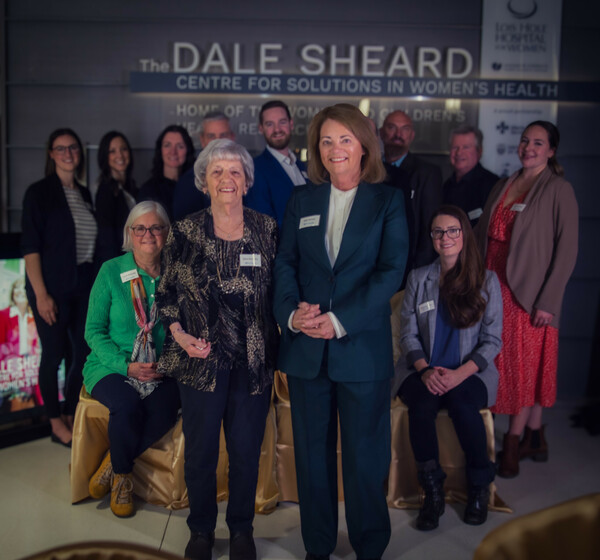 Dale Sheard (front, right) joined by loved ones at sign unveiling